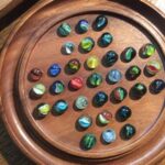 Game With Marbles And Wooden Board